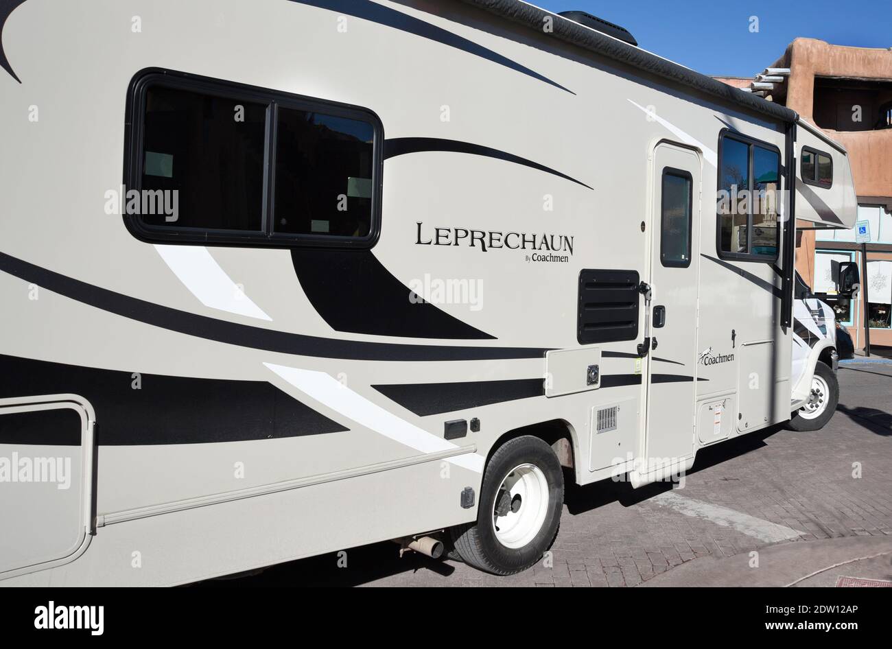 A tourist driving a Coachmen Leprechaun motorhome drives through Santa Fe, New Mexico. Coachmen is headquartered in Middlebury, Indiana. Stock Photo