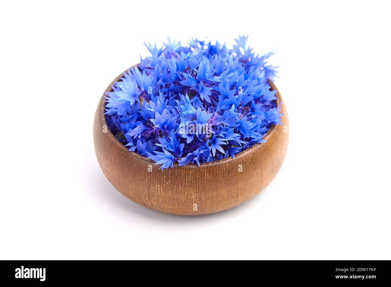 Cornflower flowers buds in wooden bowl isolated on white background