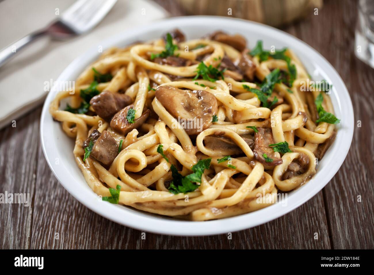 Tagliatelle with mushrooms on a plate. High quality photo. Stock Photo