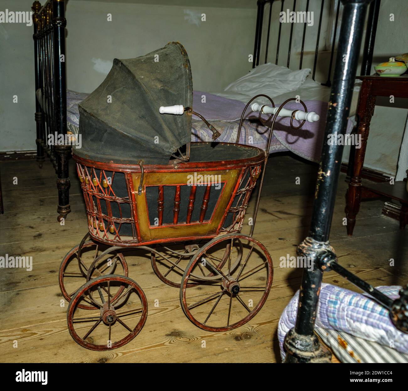 Vintage antique baby stroller in old style dark bedroom, with two old beds  and blankets Stock Photo - Alamy
