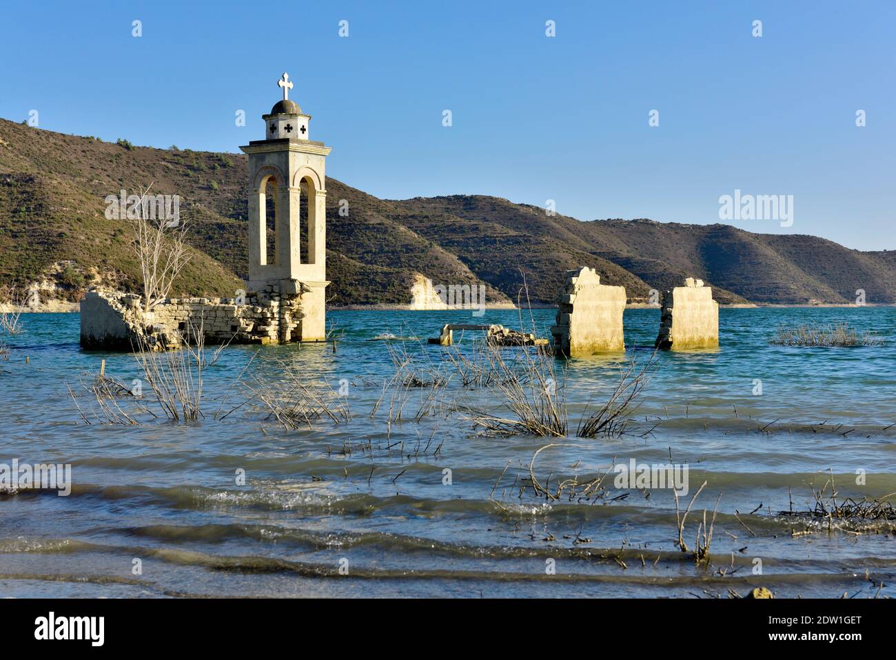 Ruins of Old Church of Saint Nicholas partly submerged in Kouris Reservoir when Alassa village was abandoned to the rising water Stock Photo
