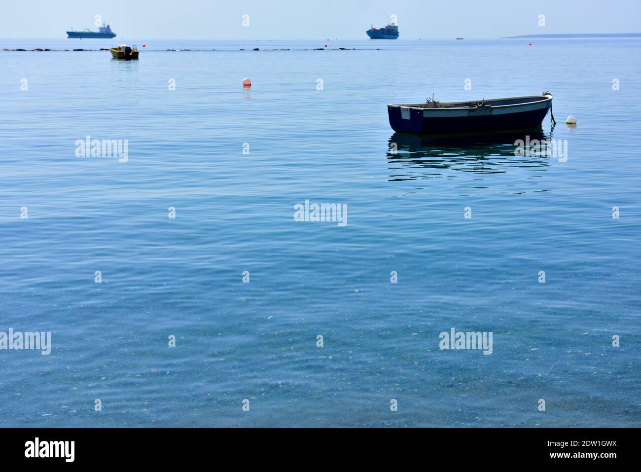 Mediterranean sea, calm water, with breakwater, boats and ships off Limassol, Cyprus Stock Photo