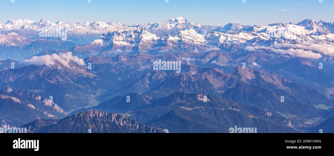 Aerial panoramic banner view of the Swiss Alps with green valley and ...
