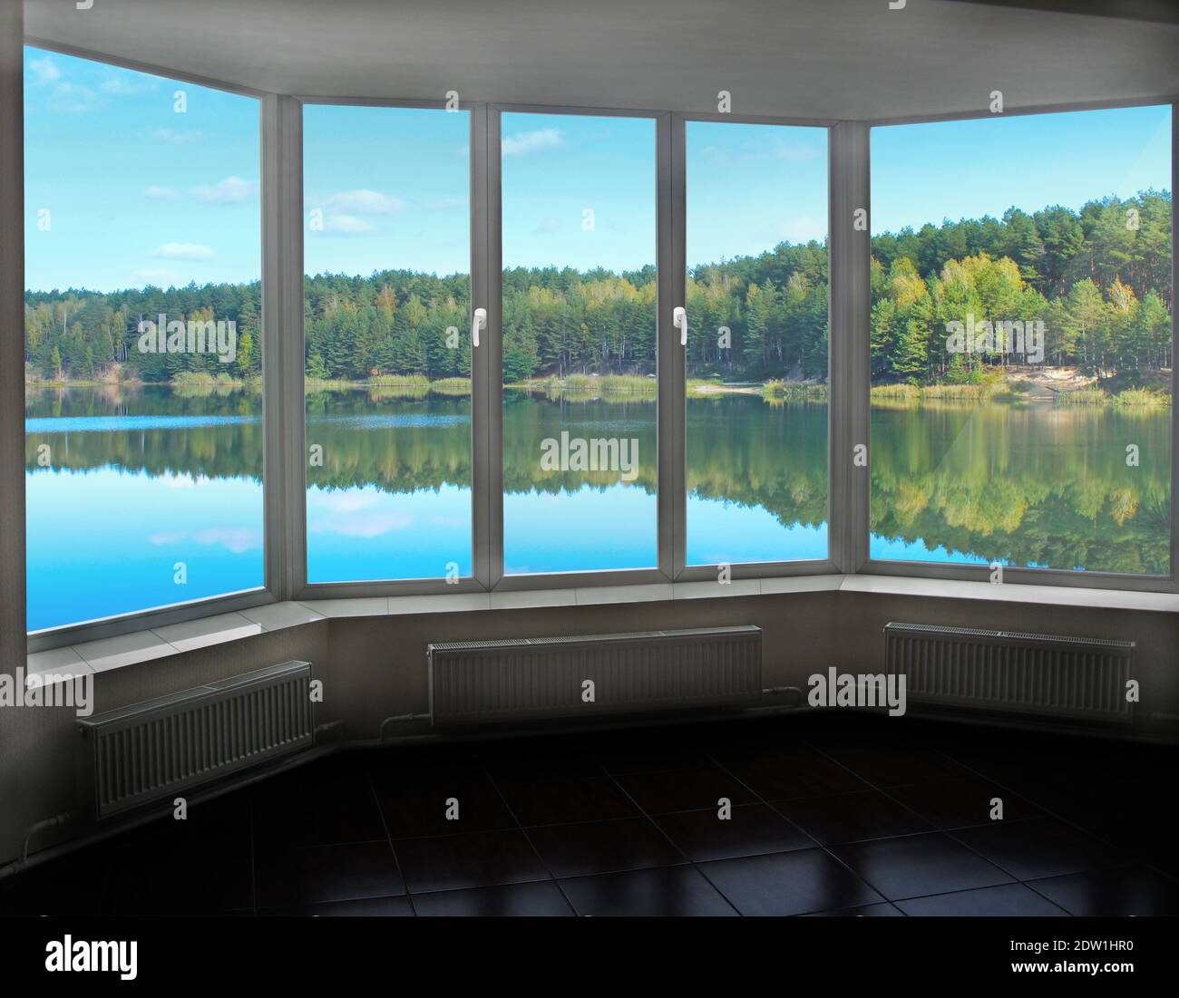 Room with big window in room with panoramic view to forest lake ...