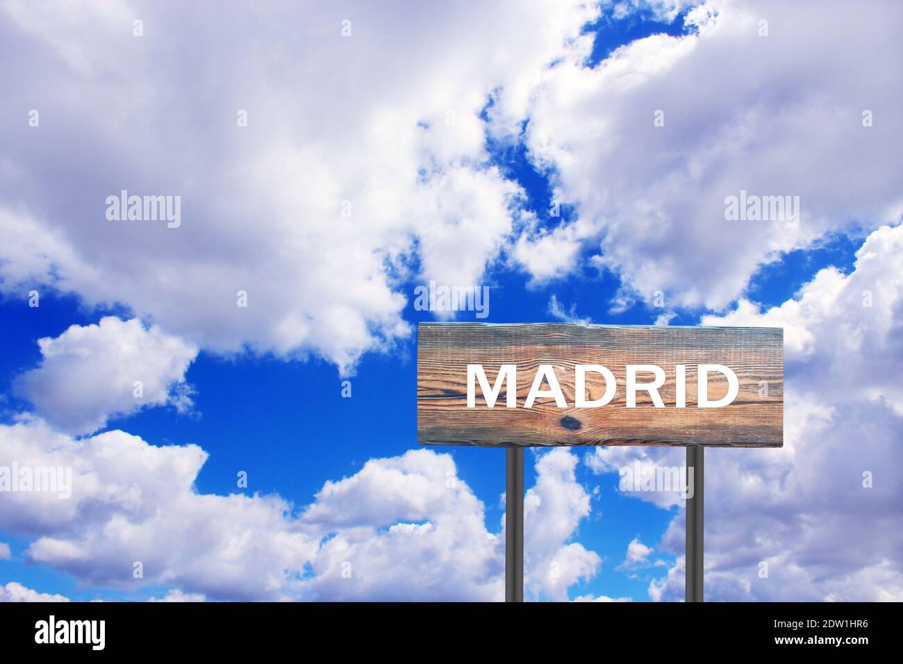 Sign with inscription Madrid with view of sky. Pointer of the settlement. Road sign indicating settlement. Sign about Madrid on blue and cloudy sky ba Stock Photo