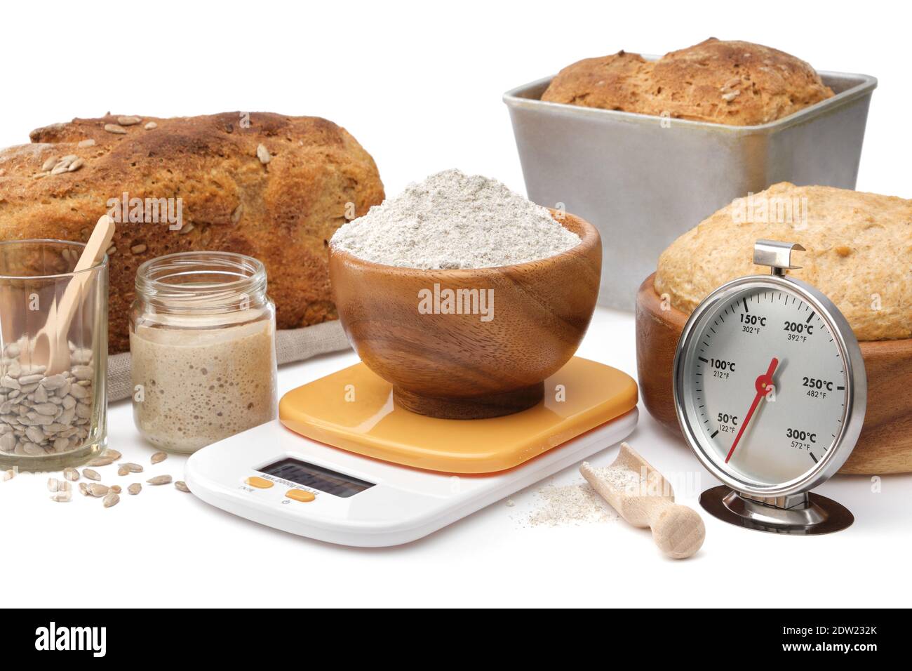 Homemade sourdough bread, natural leaven for bread in a glass jar, wooden  bowl of dough, kitchen scale, a bowl of flour and oven thermometer on white  Stock Photo - Alamy
