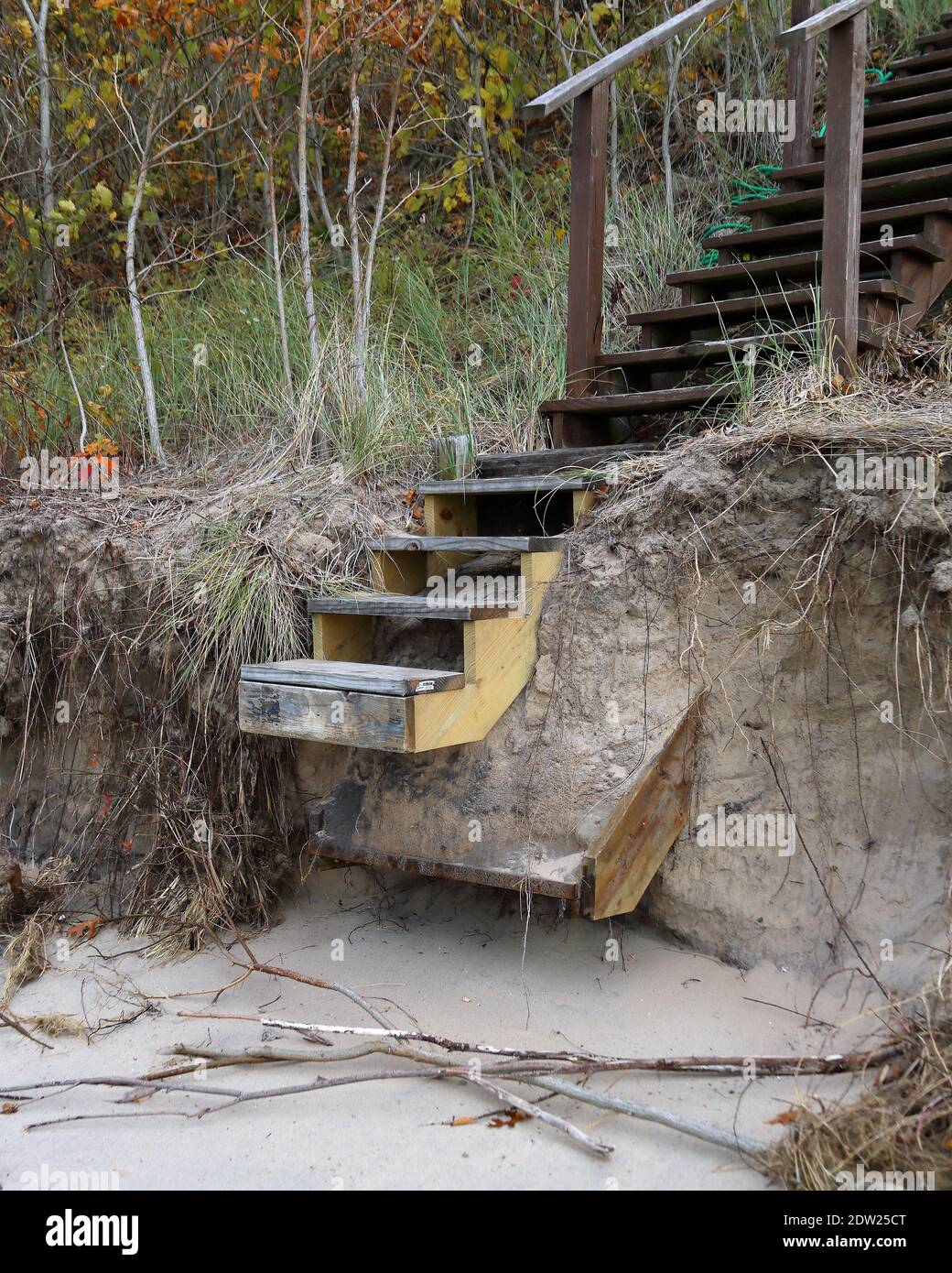 Erosion damaged wooden staircase built on the sandy edge of Lake Michigan Stock Photo
