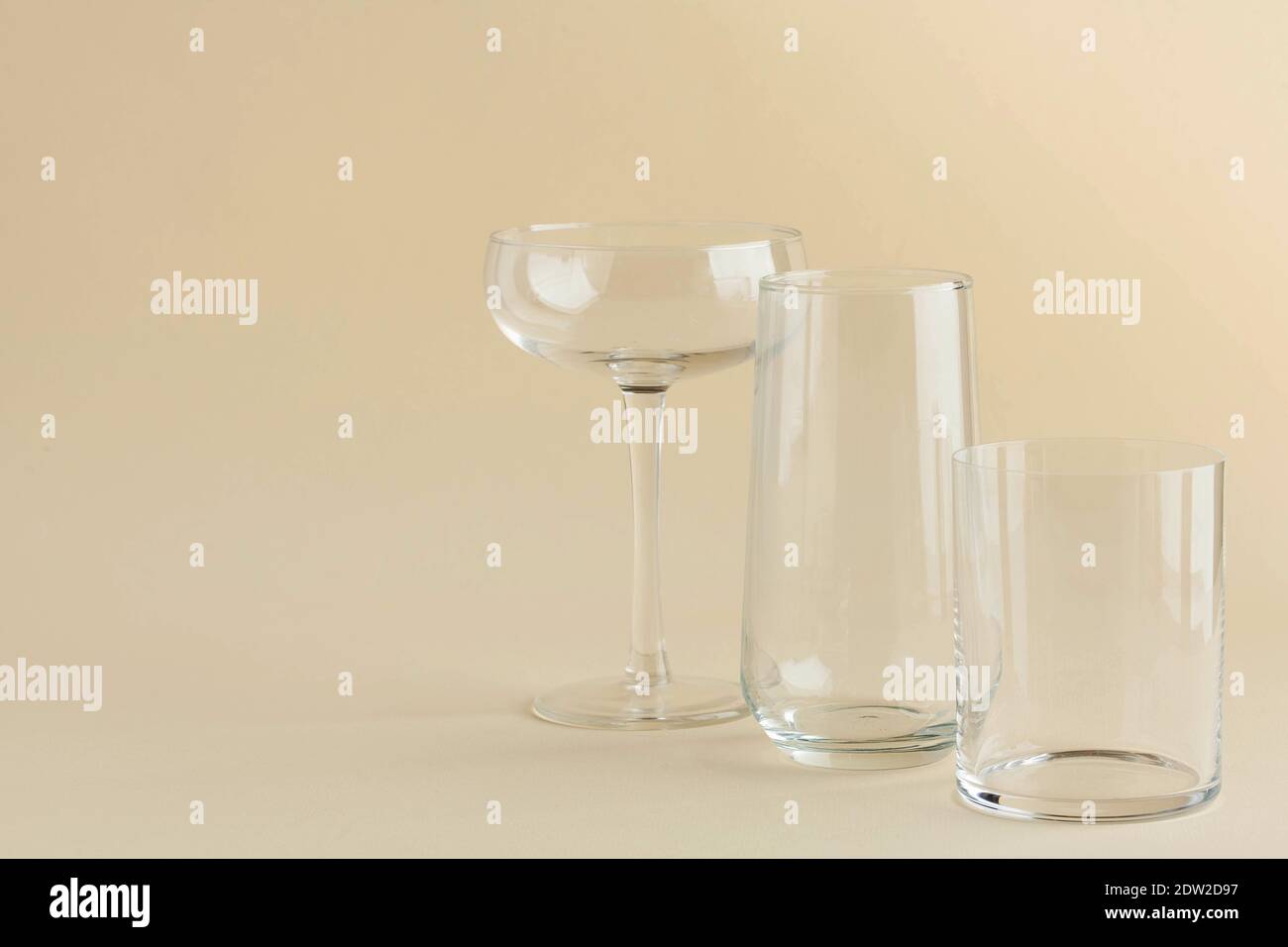 Empty clear glass glasses, glasses on a beige background. Minimalism ...
