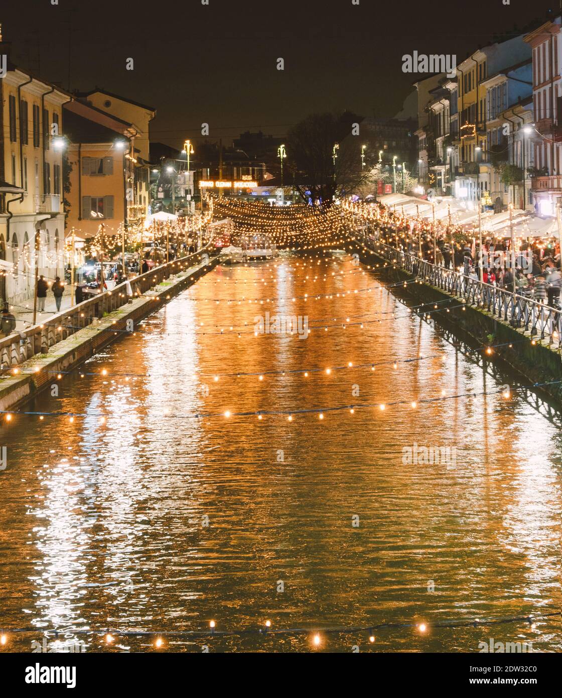 festive crowd on the shores of the illuminated Navigli in the Christmas holidays.Milan, Italy. Stock Photo