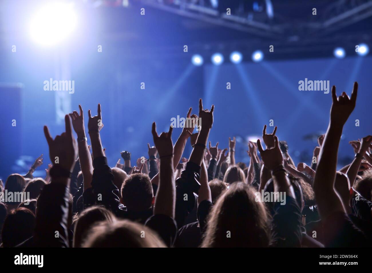 Silhouettes of people in the rock concert in front of the stage. Stock Photo