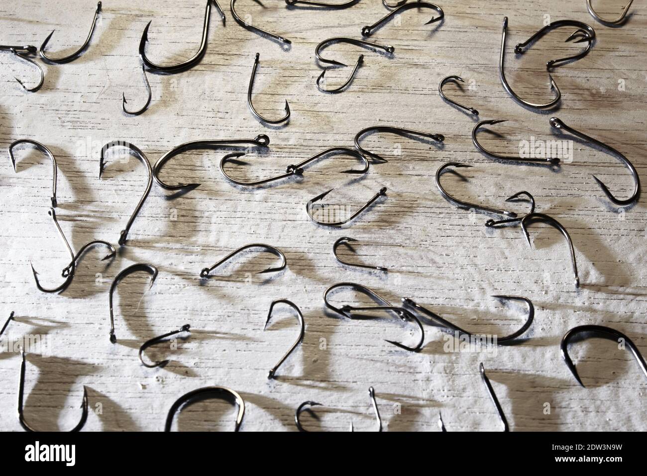 picture on white background full of fishing hooks Stock Photo