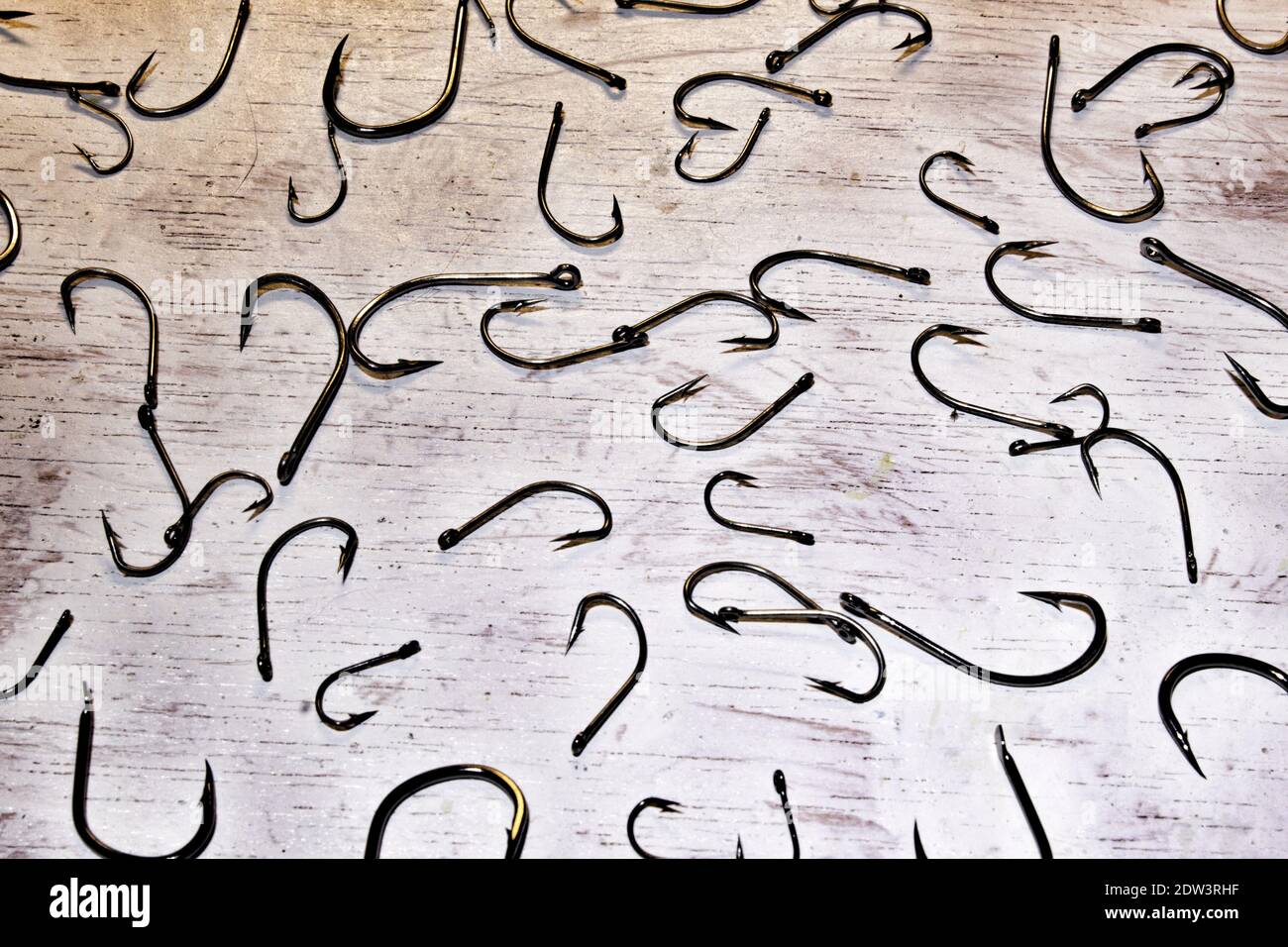 picture on white background full of fishing hooks Stock Photo - Alamy