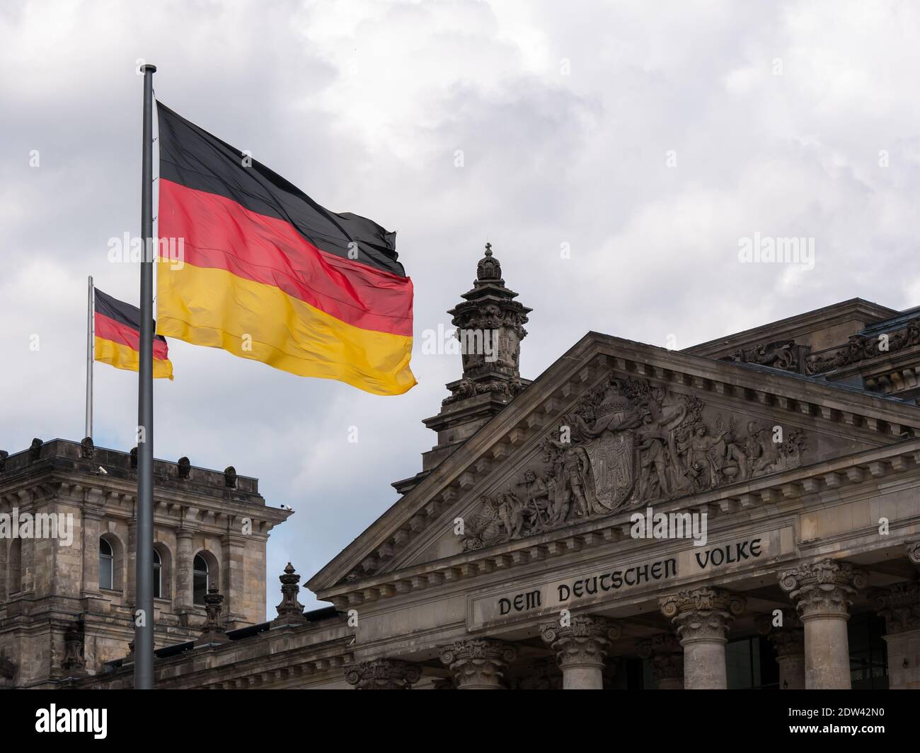 German Politics Concept: Germany Flags In Front of The Reichstag Building In Berlin, Germany Stock Photo