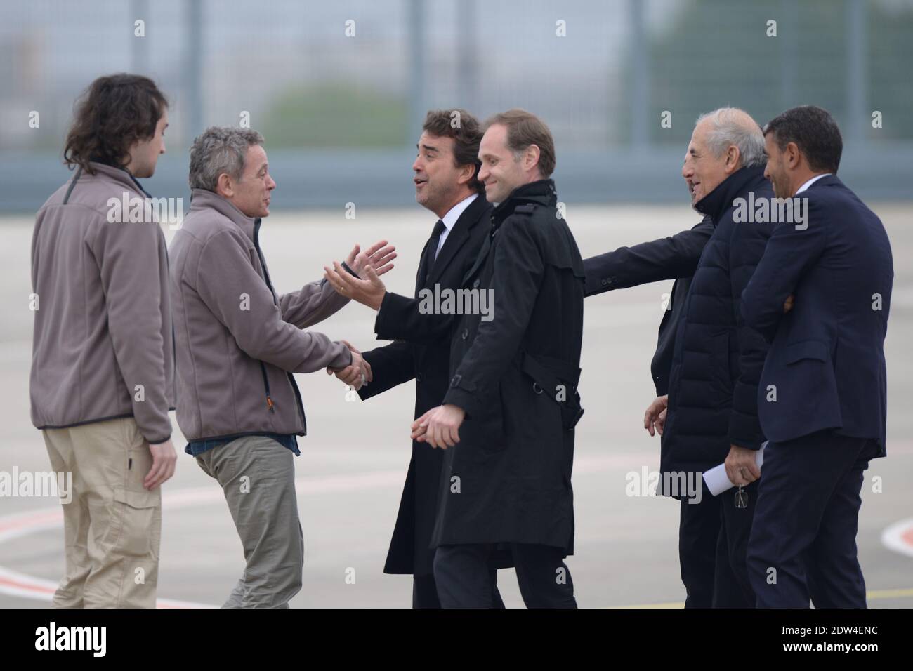 French reporters Didier Francois (2nd from L), Edouard Elias (1st from L) who were held hostages in Syria for 10 months, seen with Arnaud Lagardere (center), Fabien Namias, Jean Pierre Elkabbach and Ramzi Khiroun, as they are back at Villacoublay military base, near Paris, France, on April 20th, 2014. Photo by Ammar Abd Rabbo/ABACAPRESS.COM Stock Photo