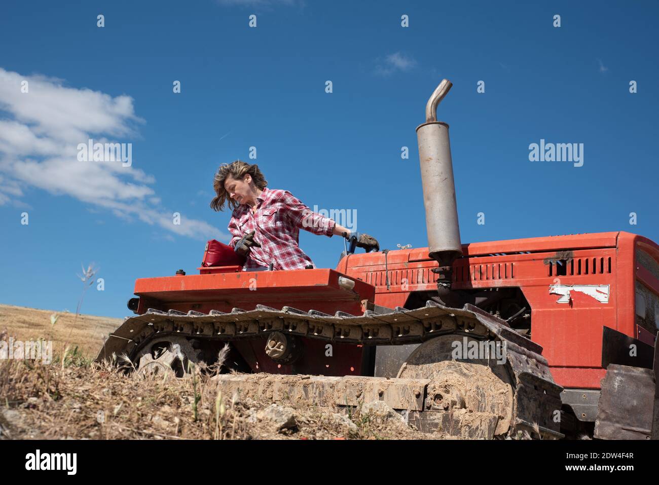 Woman farmer driving a tractor Stock Photo - Alamy