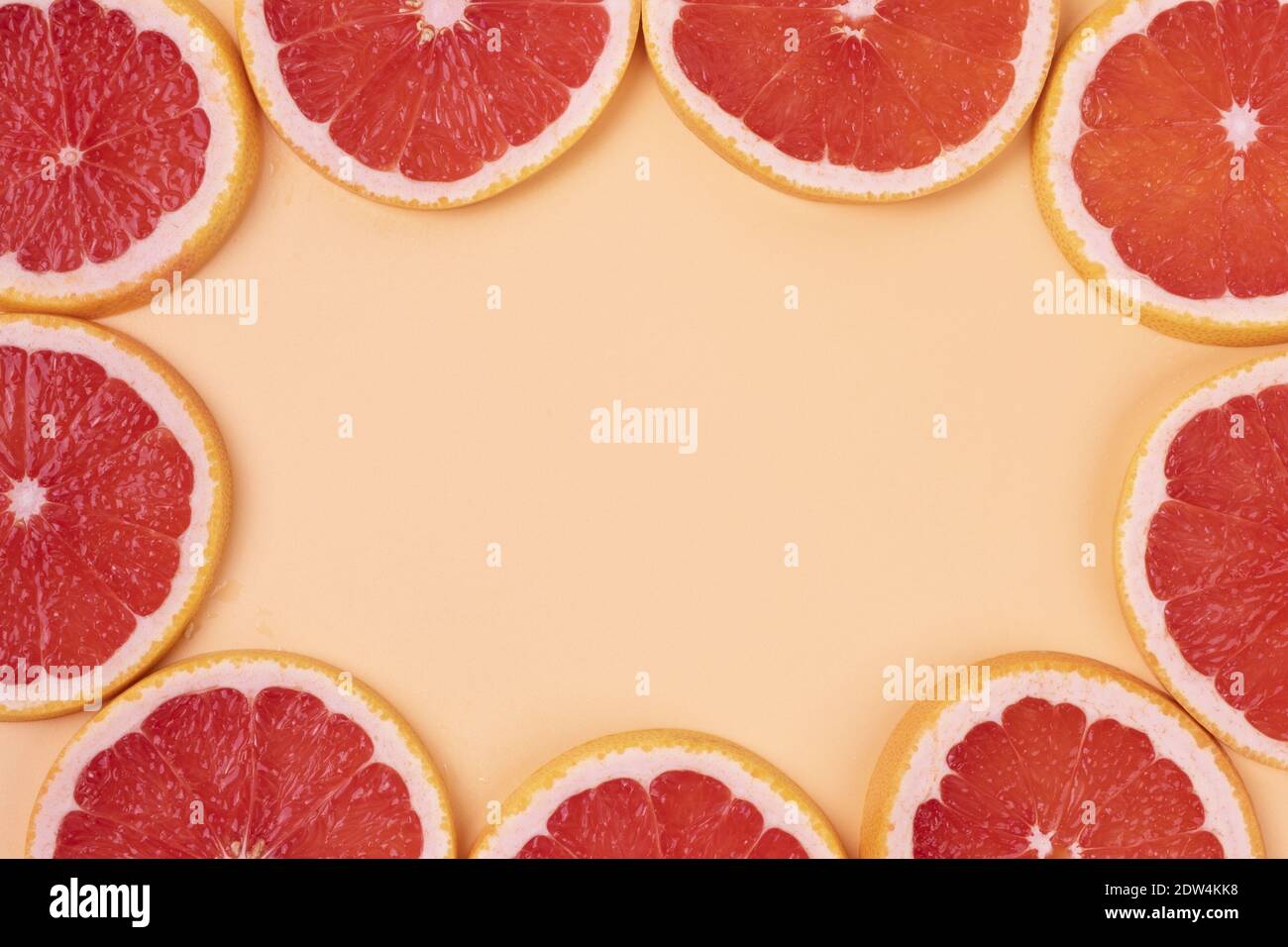 Fresh grapefruit slices for a wallpaper background with copyspace in