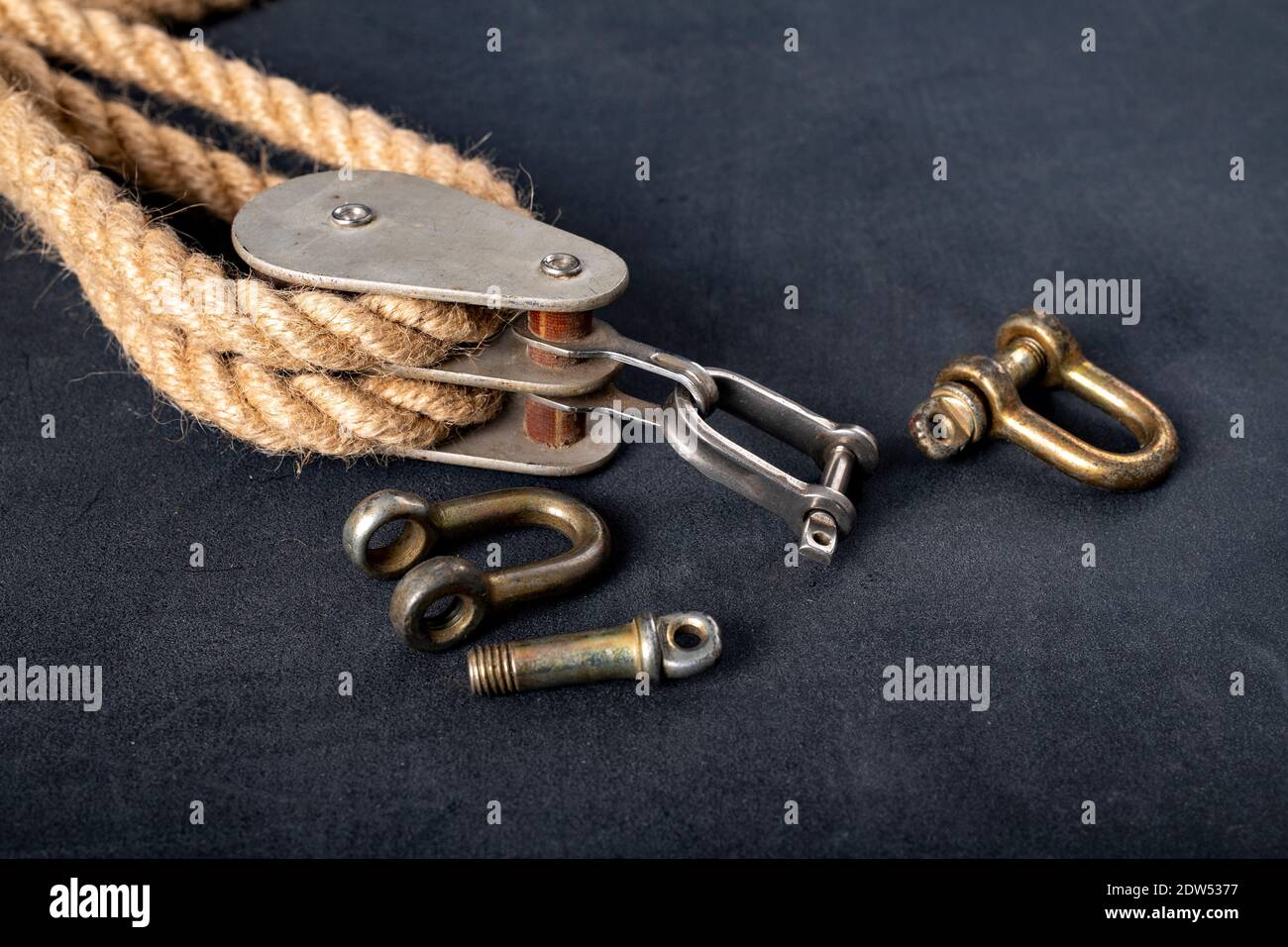 Thick jute rope, two pulleys and a shackle. Sailing accessories used on