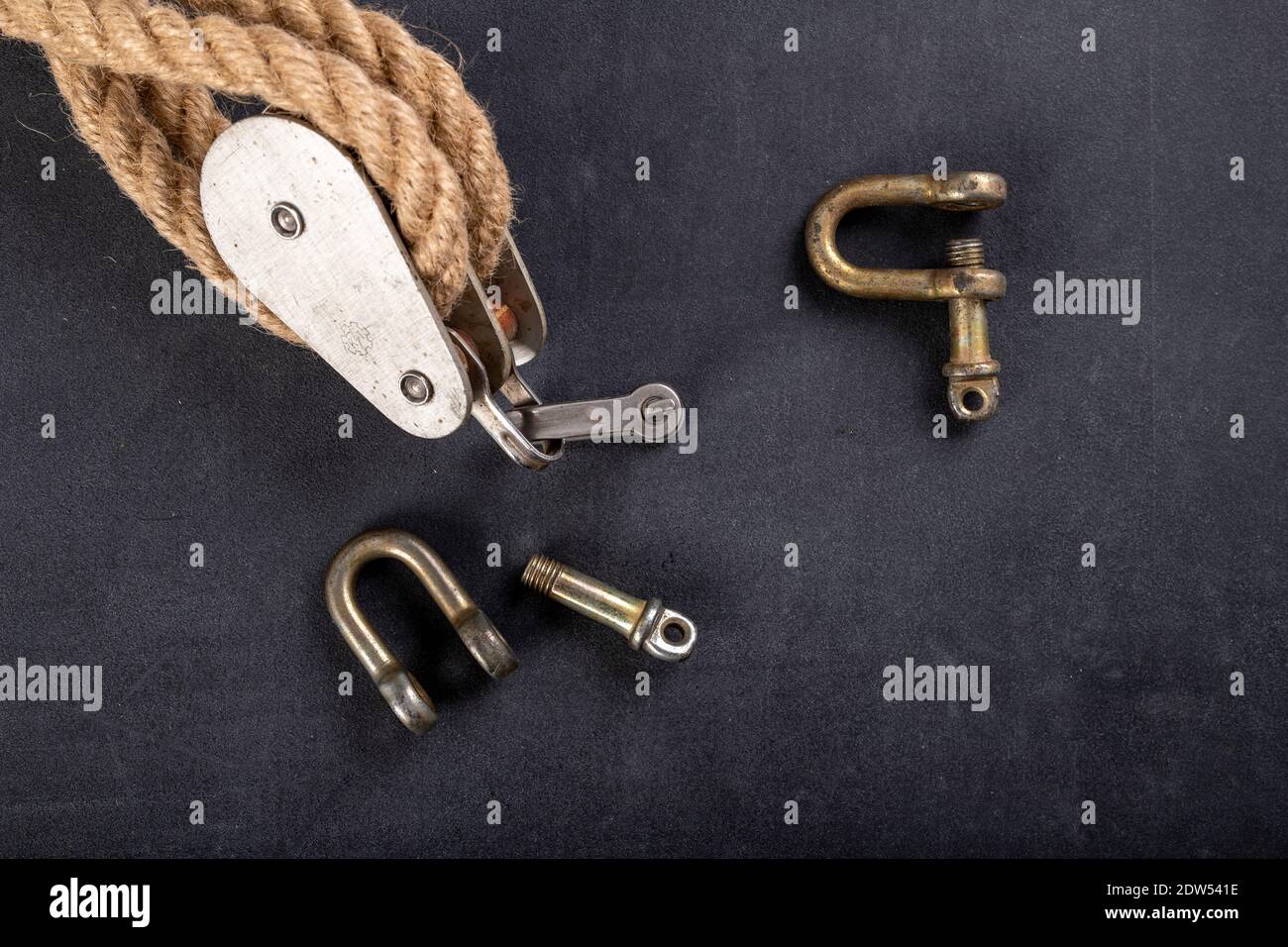 Thick jute rope, two pulleys and a shackle. Sailing accessories used on