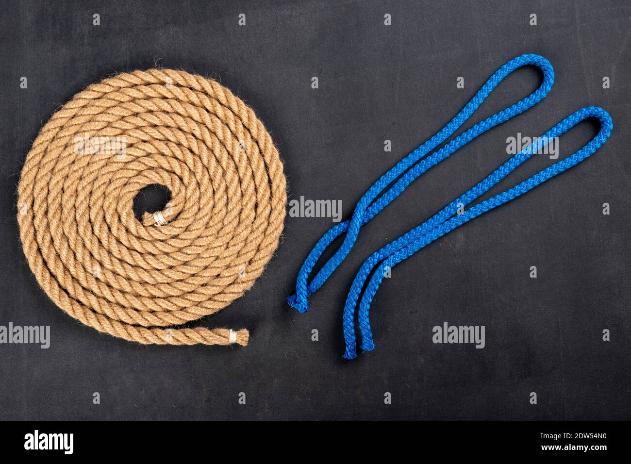 Thick jute rope coiled into a circle and short lines for tying the sails.  Sailing accessories used on yachts. Dark background Stock Photo - Alamy