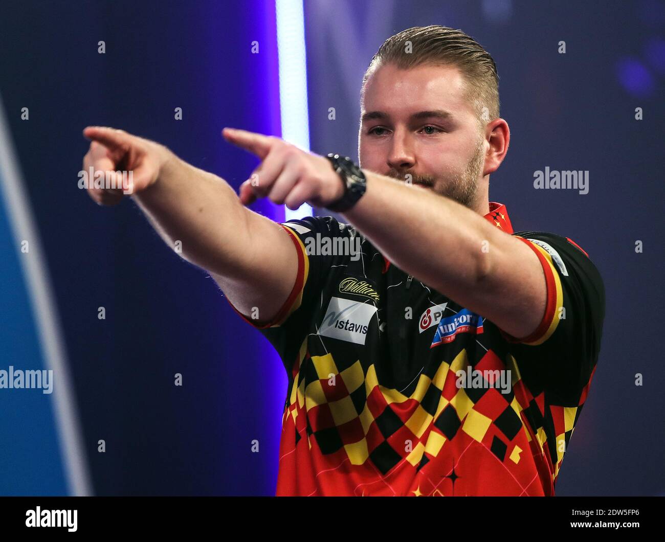 Dimitri Van den Bergh points at Paul Lim as he walks off stage during day eight of the William Hill World Darts Championship at Alexandra Palace, London. Stock Photo