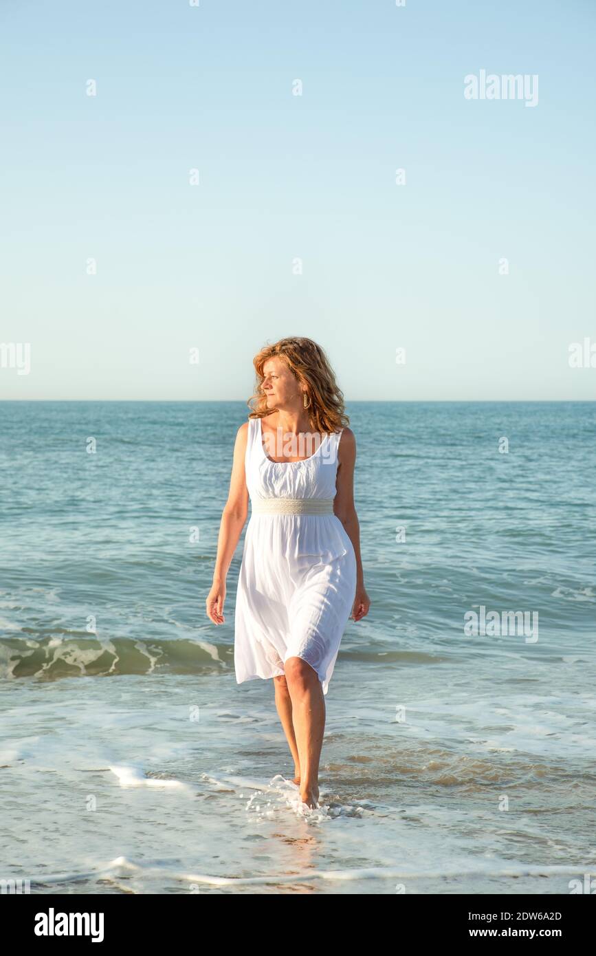 Mature woman enjoying herself on the beach Stock Photo - Alamy