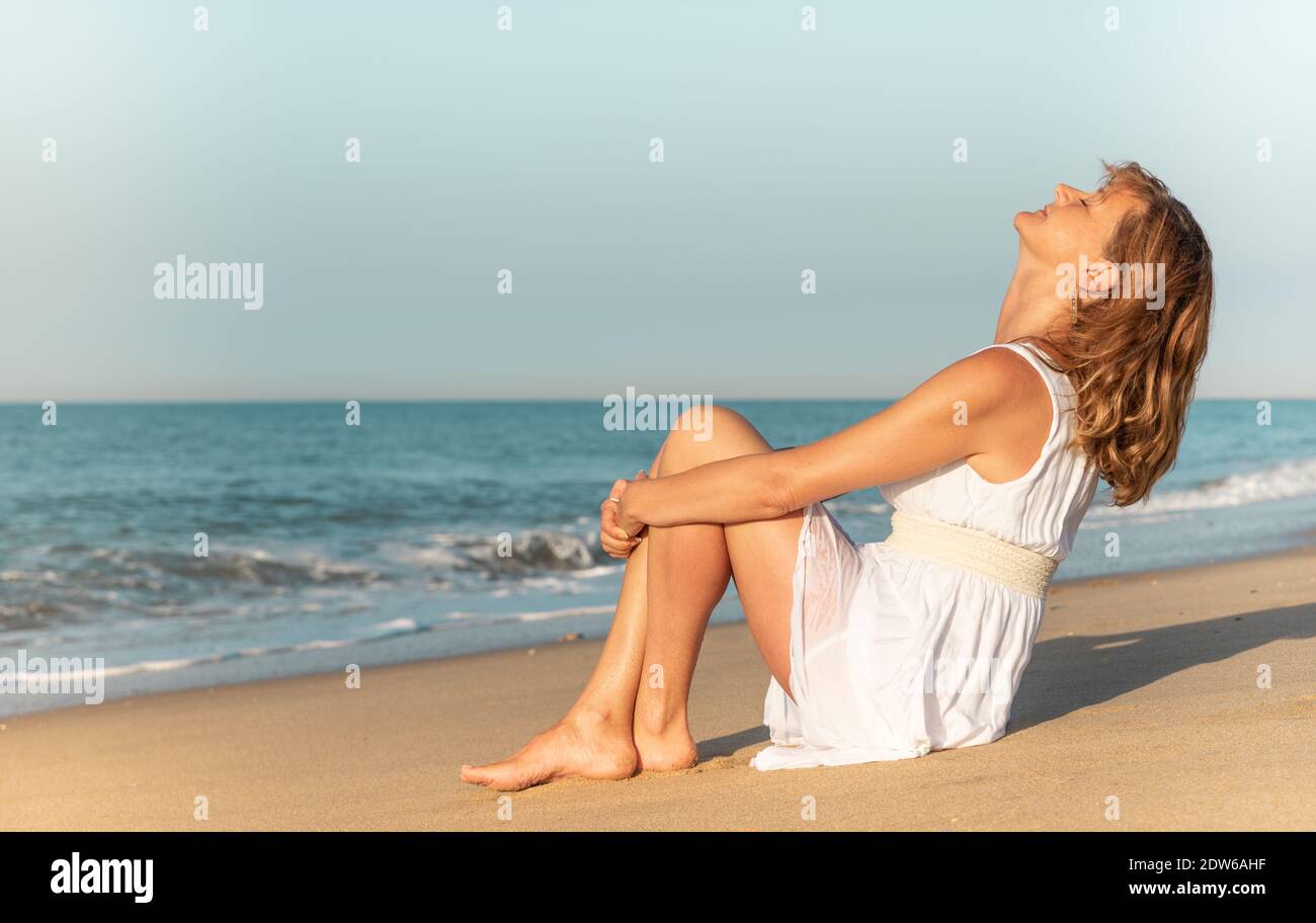 Mature woman enjoying herself on the beach Stock Photo - Alamy