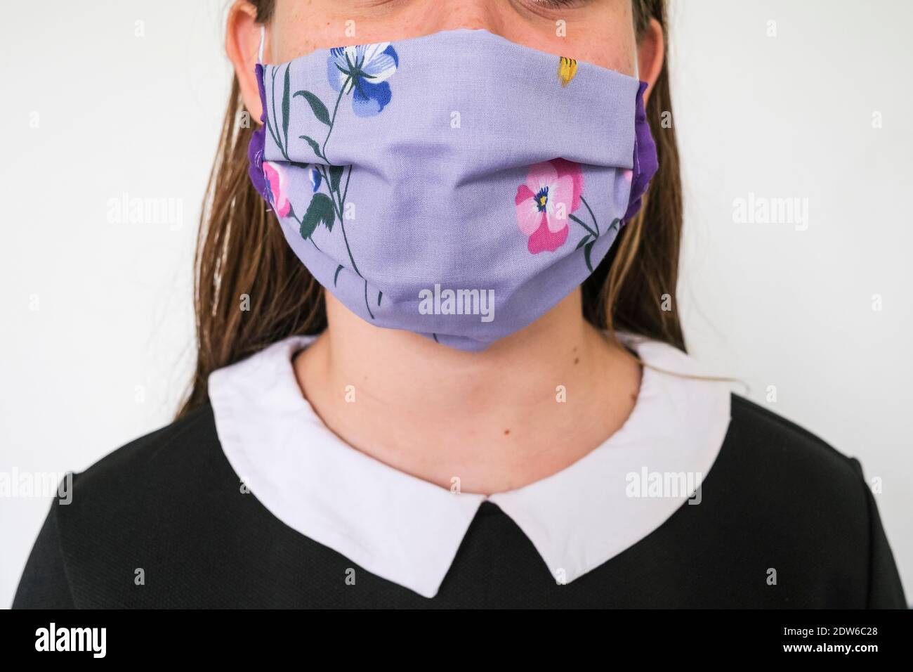Unrecognisable portrait of a young girl with a homemade face mask to ...