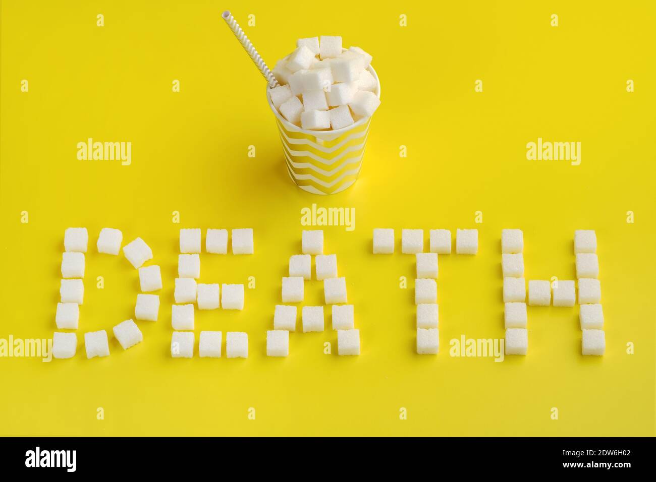 Word death from sugar cubes and disposable paper cup with straw Stock Photo