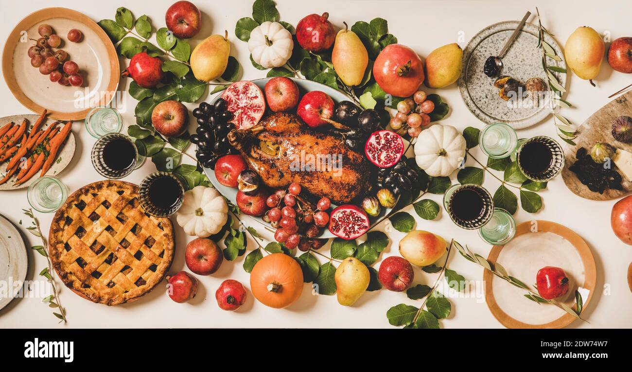 Autumn Thanksgiving, Friendsgiving, family party gathering celebration table setting. Flat-lay of Fall table with roasted duck, vegetable, cheese boar Stock Photo