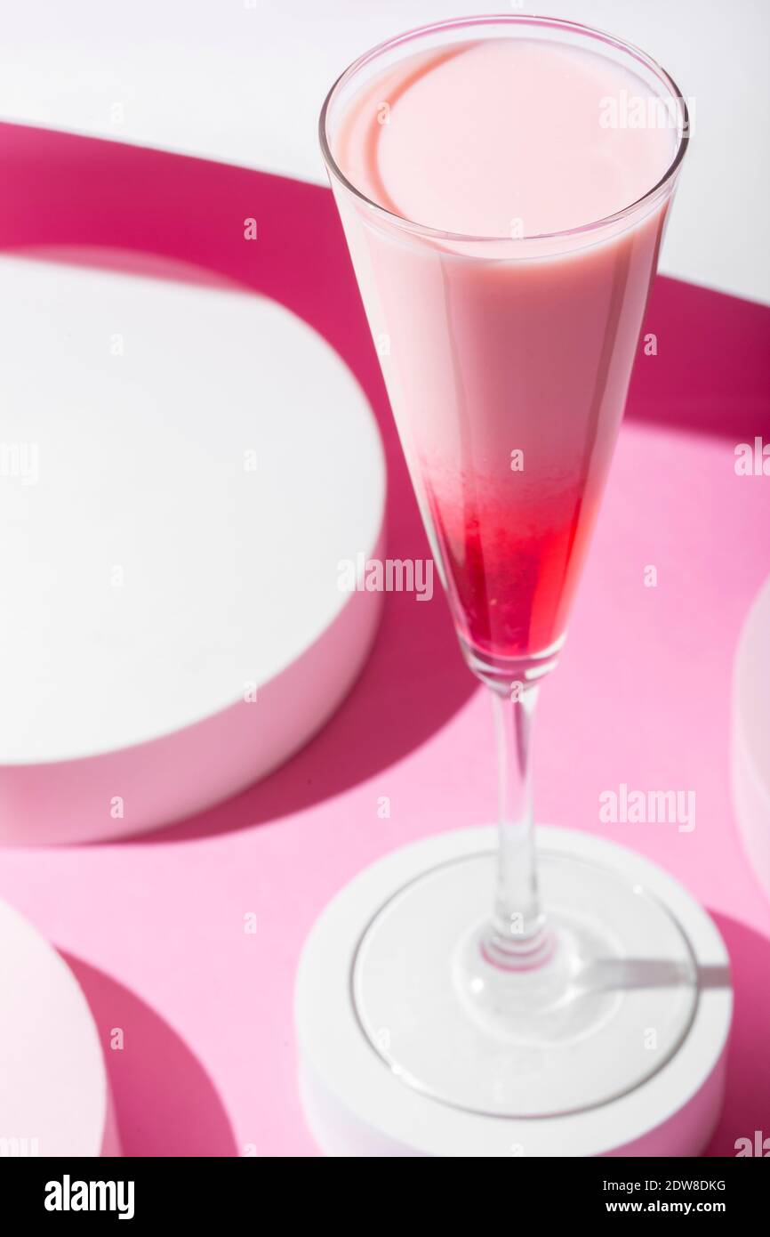 Pink cocktail on a pink background. Minimalistic set design Stock Photo
