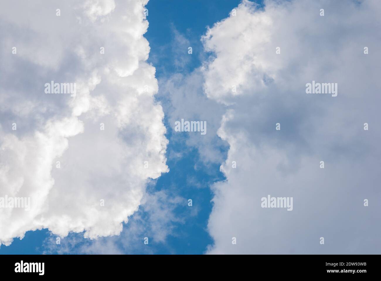blue sky in gap between heavy cumulus clouds, clearing up of weather Stock Photo