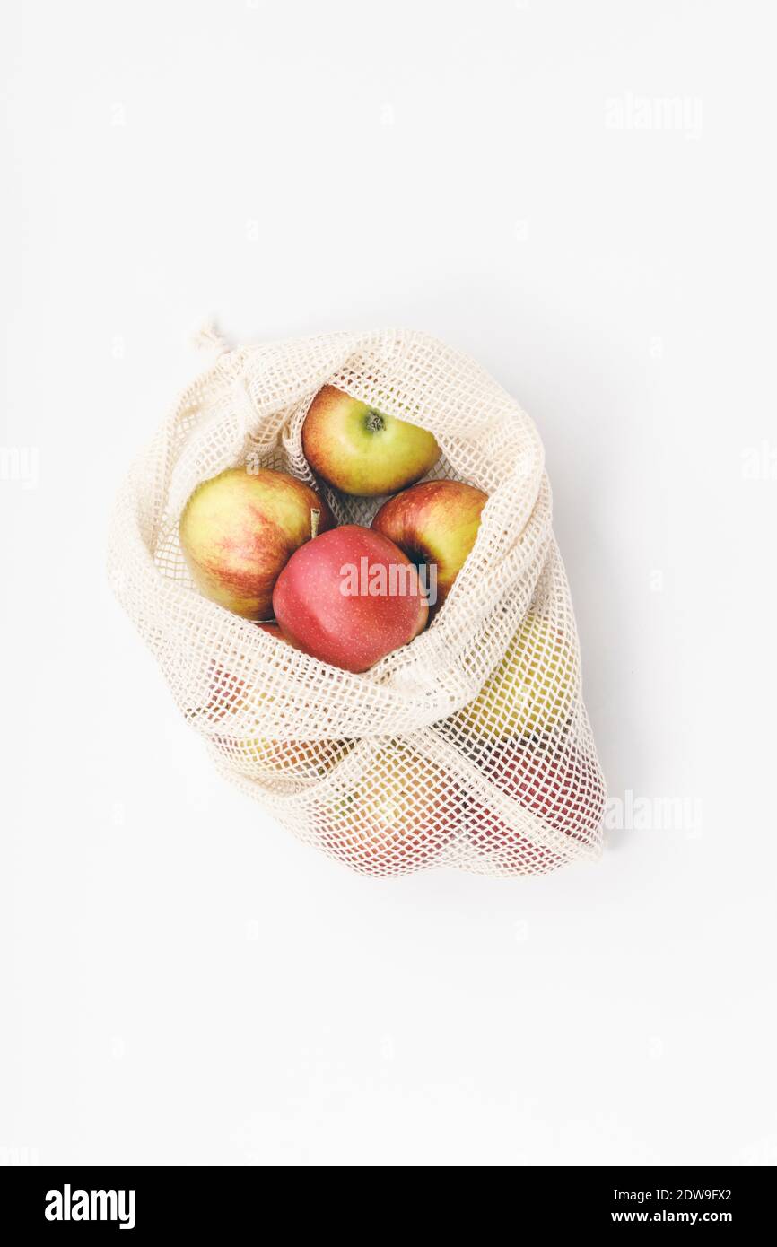 Red apples in reusable cotton bags. Zero waste, Recycling, Sustainable lifestyle concept Stock Photo