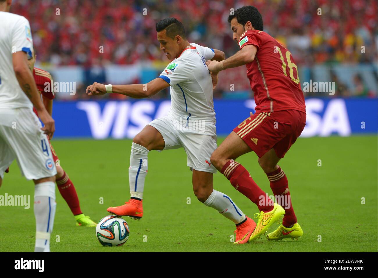 Spain's Sergio Busquets battling Chile's Alexis Sanchez during Soccer World Cup 2014 First round Group B match Spain v Chile at Maracana Stadium, Rio de Janeiro, Brazil , on June 18, 2014. Chile won 2-0 and ousted the defending champions from the competition. Photo by Henri Szwarc/ABACAPRESS.COM Stock Photo