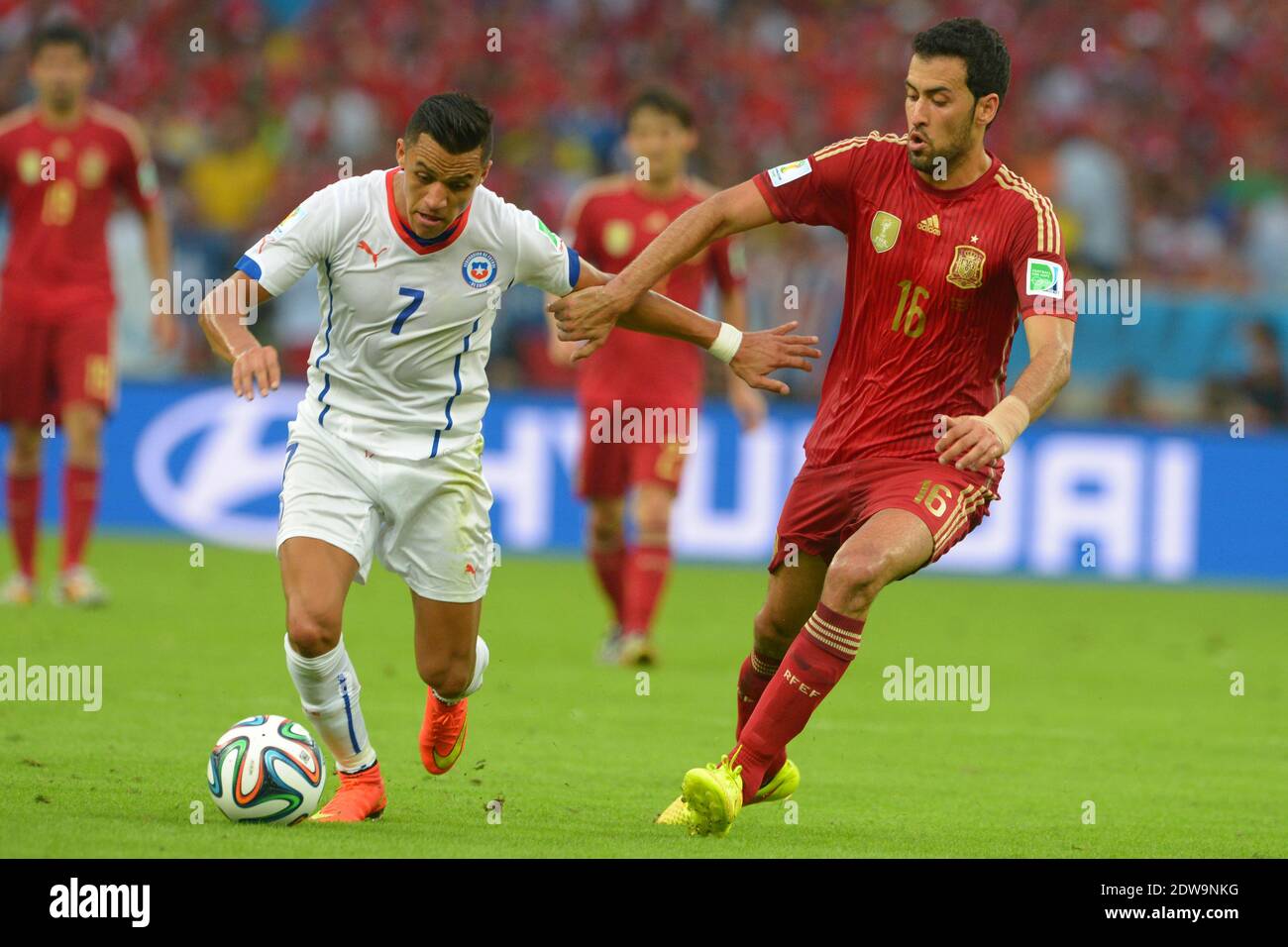 Spain's Sergio Busquets battling Chile's Alexis Sanchez during Soccer World Cup 2014 First round Group B match Spain v Chile at Maracana Stadium, Rio de Janeiro, Brazil , on June 18, 2014. Chile won 2-0 and ousted the defending champions from the competition. Photo by Henri Szwarc/ABACAPRESS.COM Stock Photo