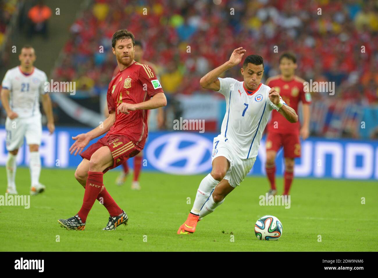 Spain's Xabi Alonso battling Chile's Alexis Sanchez during Soccer World Cup 2014 First round Group B match Spain v Chile at Maracana Stadium, Rio de Janeiro, Brazil , on June 18, 2014. Chile won 2-0 and ousted the defending champions from the competition. Photo by Henri Szwarc/ABACAPRESS.COM Stock Photo