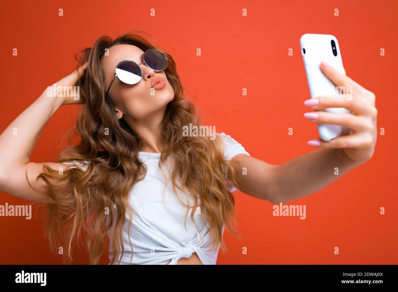 Amazing beautiful young woman holding mobile phone taking selfie photo ...