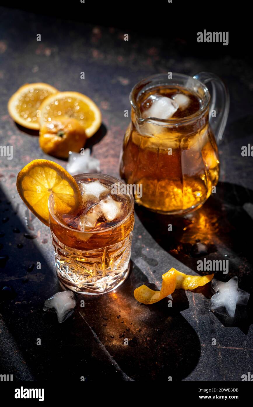 Glass of cold orange drink with ice cubes and orange slices Stock Photo