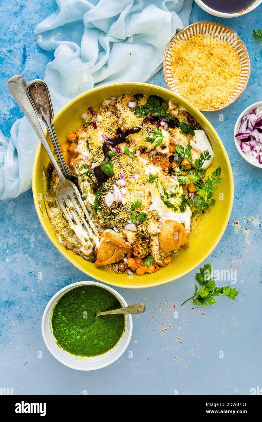 Samosa chaat made with cocktail samosa, chickpeas curry, yogurt