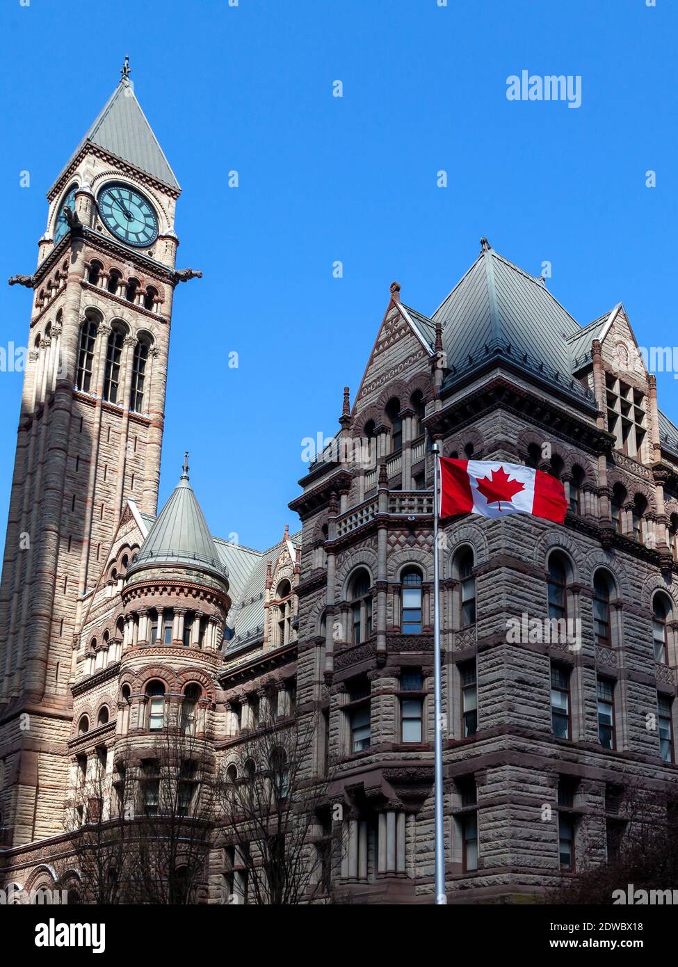 The waving Canadian flag with Old City Hall in background in Toronto, Canada. Stock Photo