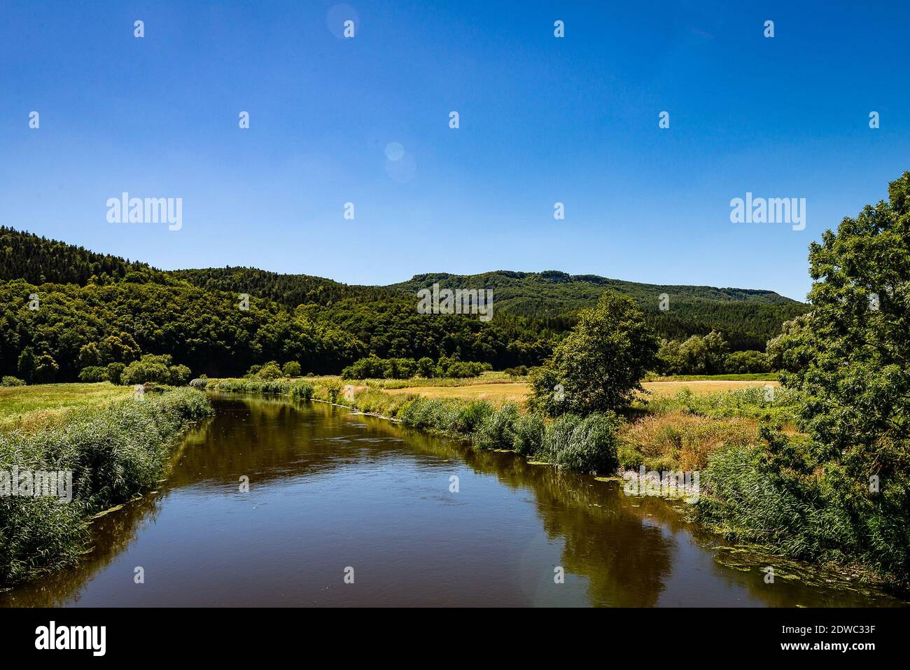Scenic View Of Lake Against Blue Sky Stock Photo