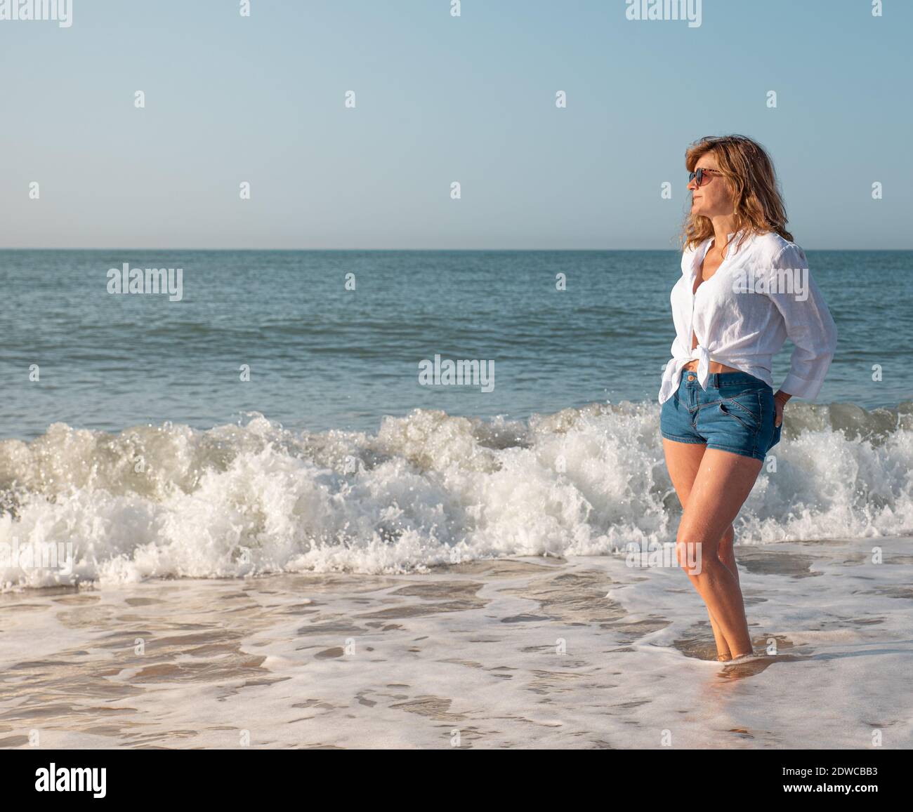 Woman on holiday enjoying the sea Stock Photo