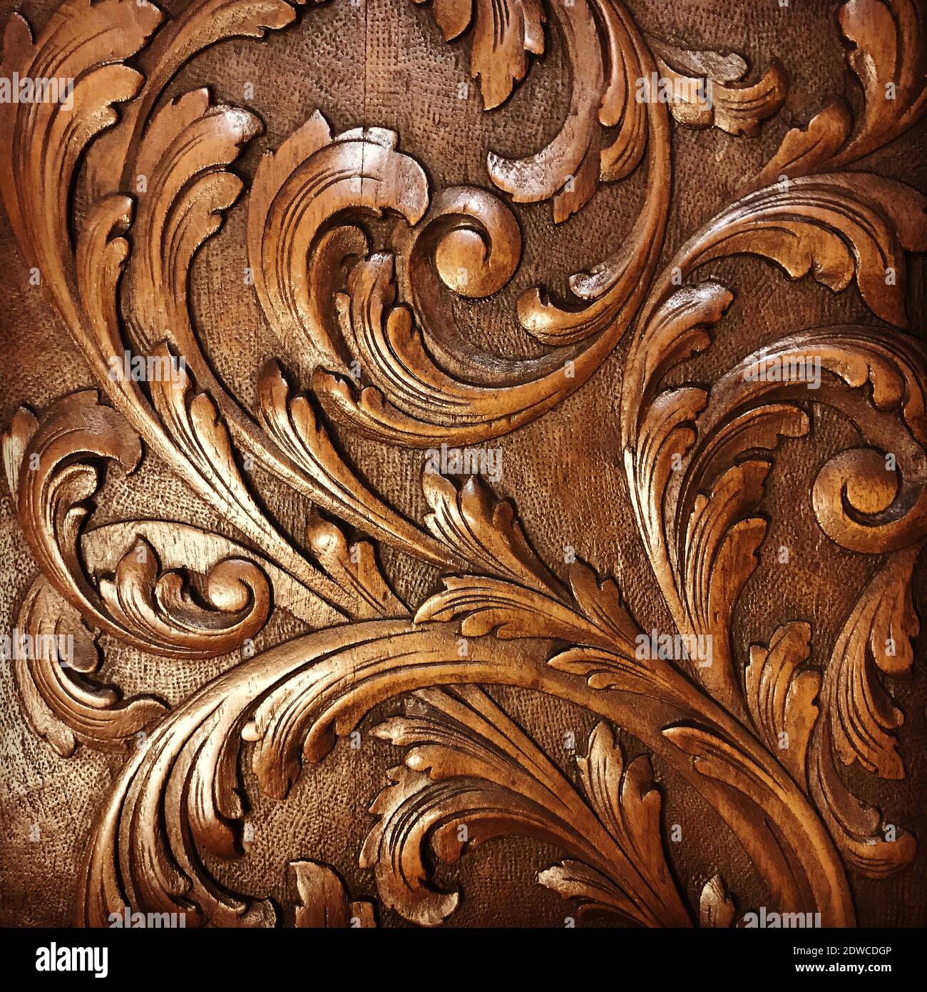 A detail photo of a carved floral pattern on a piece of antique wooden furniture. Stock Photo