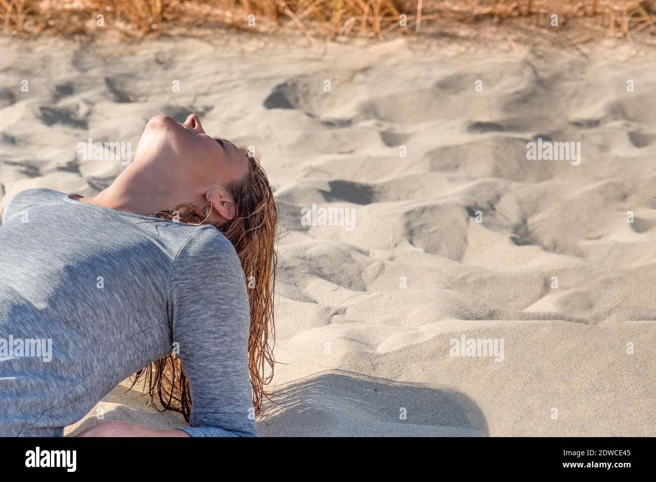 Portrait of a woman on the beach with her eyes closed Stock Photo - Alamy