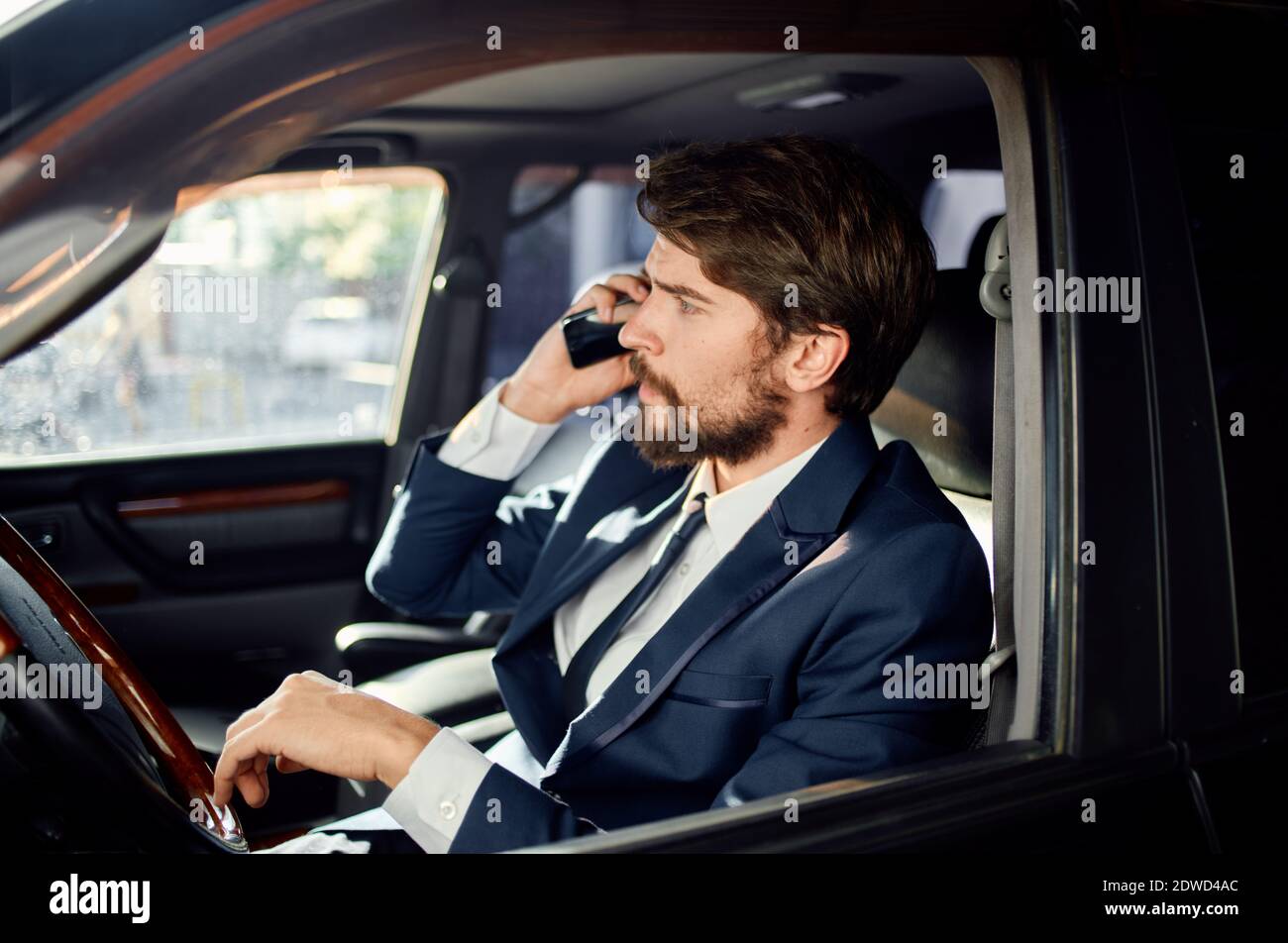 handsome man in suit driving a car trip official lifestyle Stock Photo ...