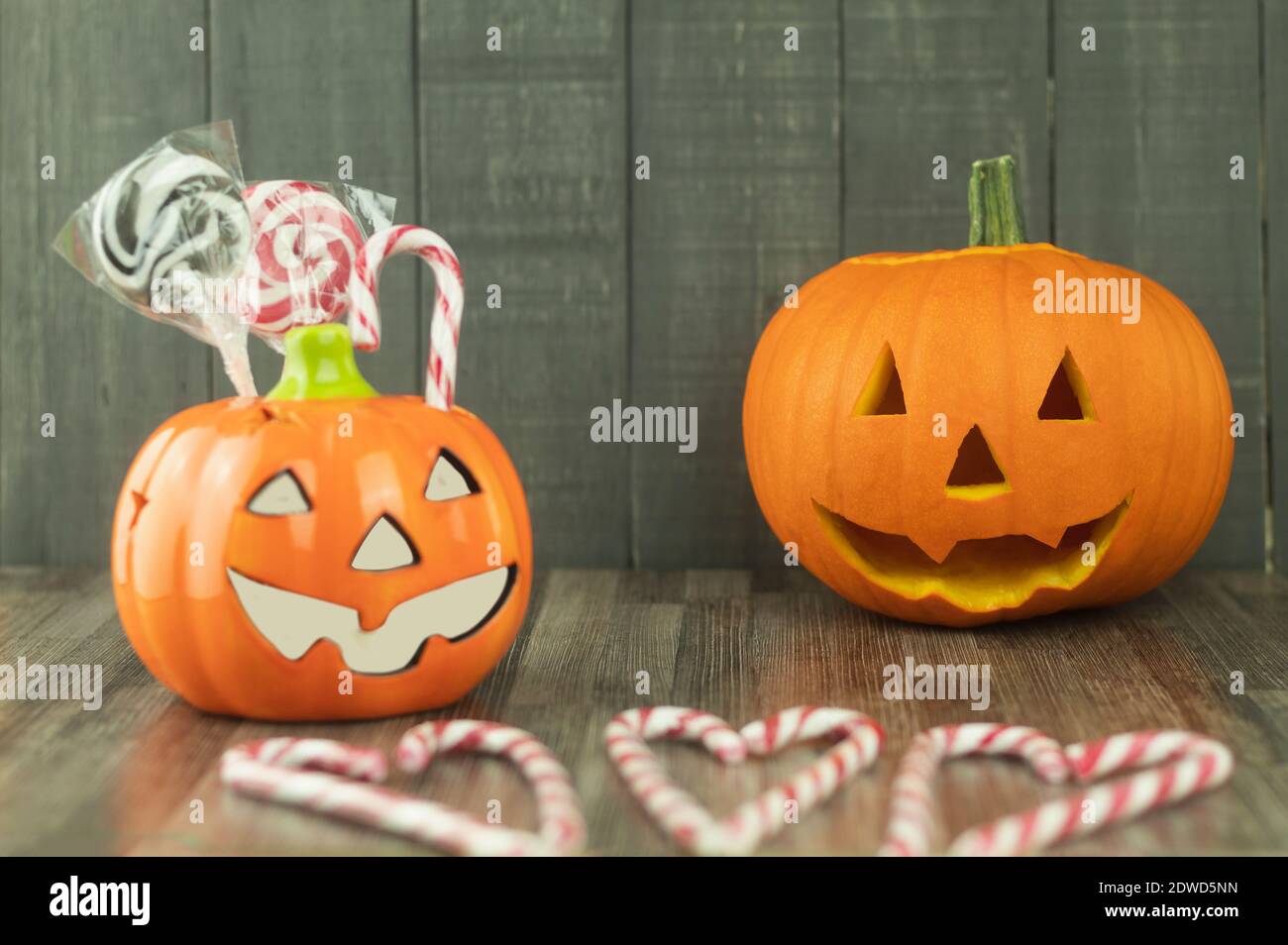 Fresh round pumpkin and candies as background. Sweets Lollipops Jellies Pumpkin Background Halloween Background Stock Photo