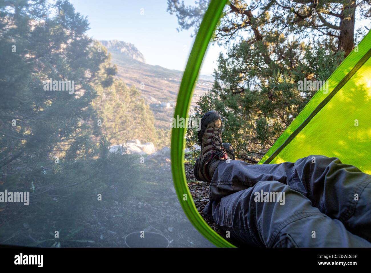 Low Section Of Man Sitting In Tent Stock Photo