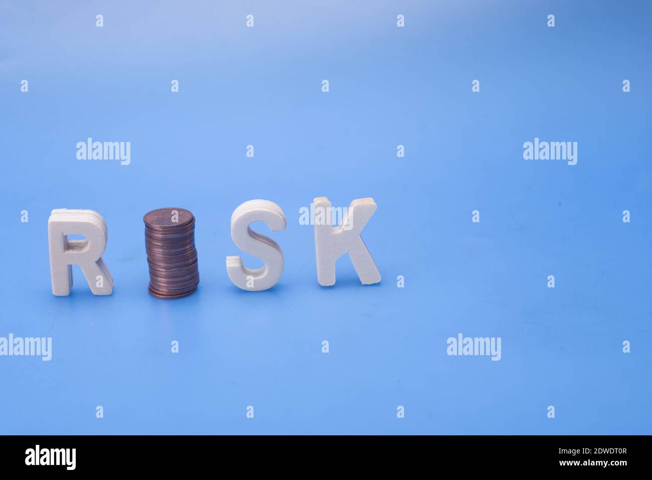 The Word Risk Isolated Over Blue Background,with Stack Of Coins,risk ...