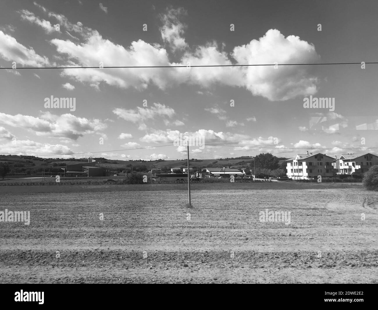 Scenic Vintage View Of Field Against Sky In Black And White Stock Photo