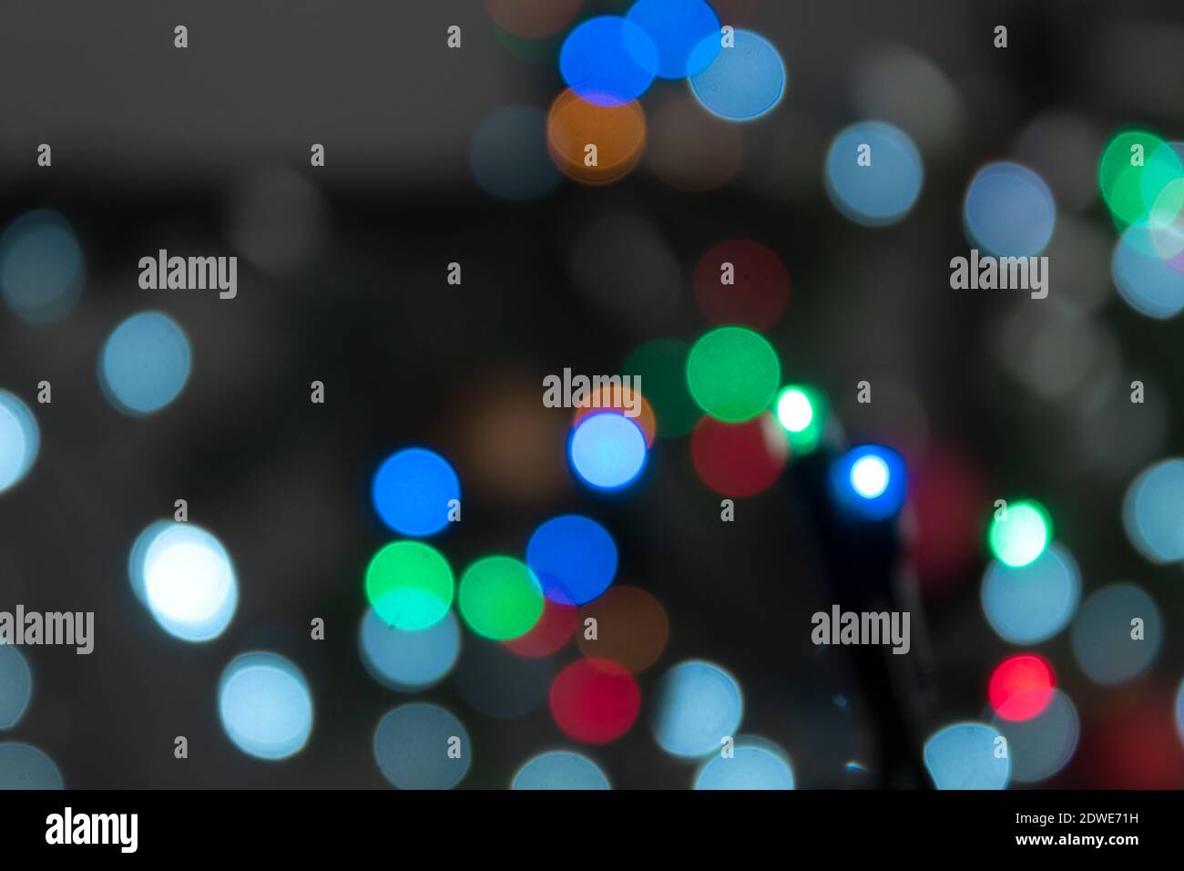 Blurred and multicolored lights garlands as a background. New Year and Christmas lights Stock Photo