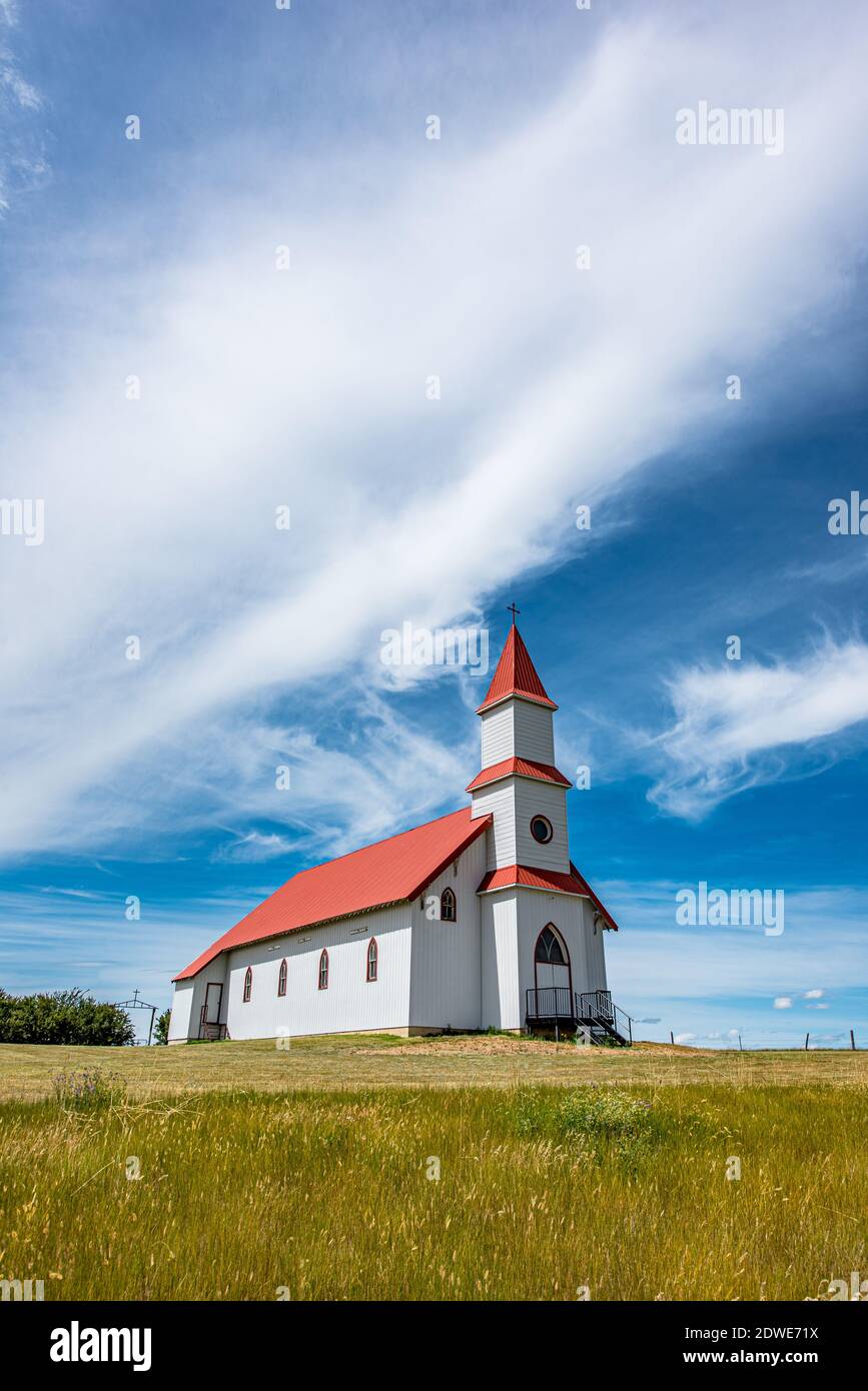 Blue sky and clouds over the historic St. Martin’s Roman Catholic Church in Billimun, Saskatchewan, Canada Stock Photo